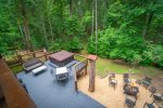 Broad view of hot tub and firepit from from lower deck
